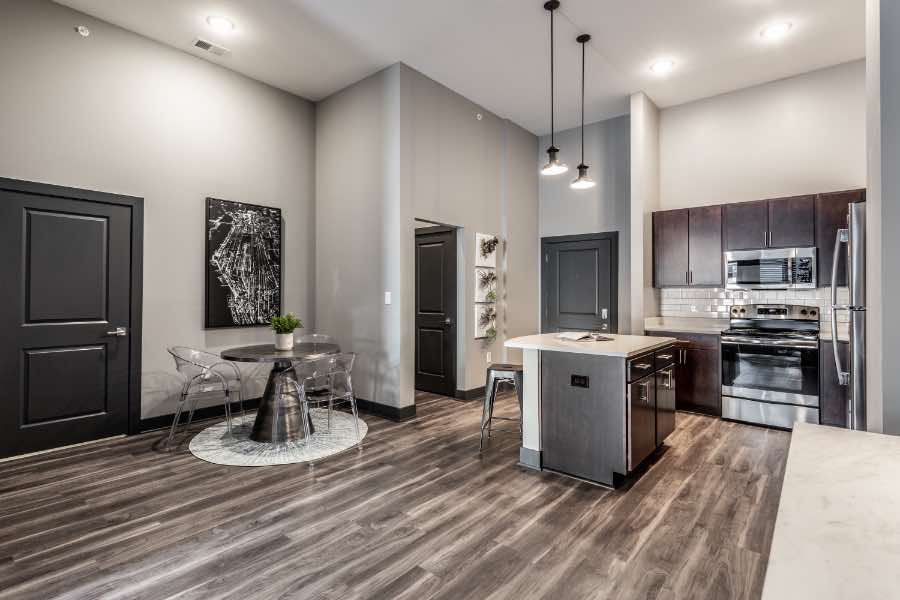 Even when moving to a spacious new unit like this one at Spark Apartments, you don't have to bring everything. Getting rid of items will make your move easier. Spacious apartment with high ceilings, stainless steel appliances, and kitchen island