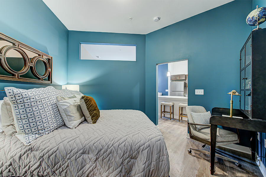 Furnishing an apartment is easy when using space-appropriate pieces like these matching nightstands. Guest bedroom with matching nightstands, table lamp, and mirror.