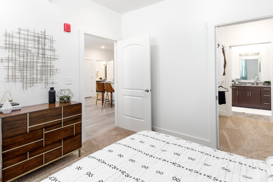 A white bedroom inside of the Echo Park Bloomington Apartments.