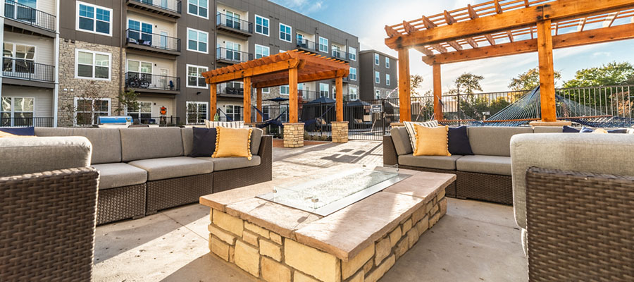 The Verge Apartments' exterior with a large patio area