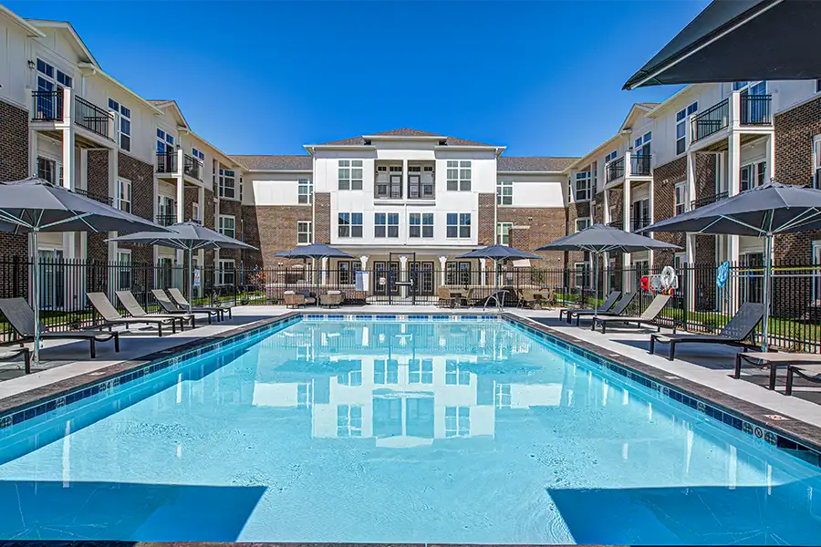 Pristine pool surrounded by apartment buildings at Verge Apartments.